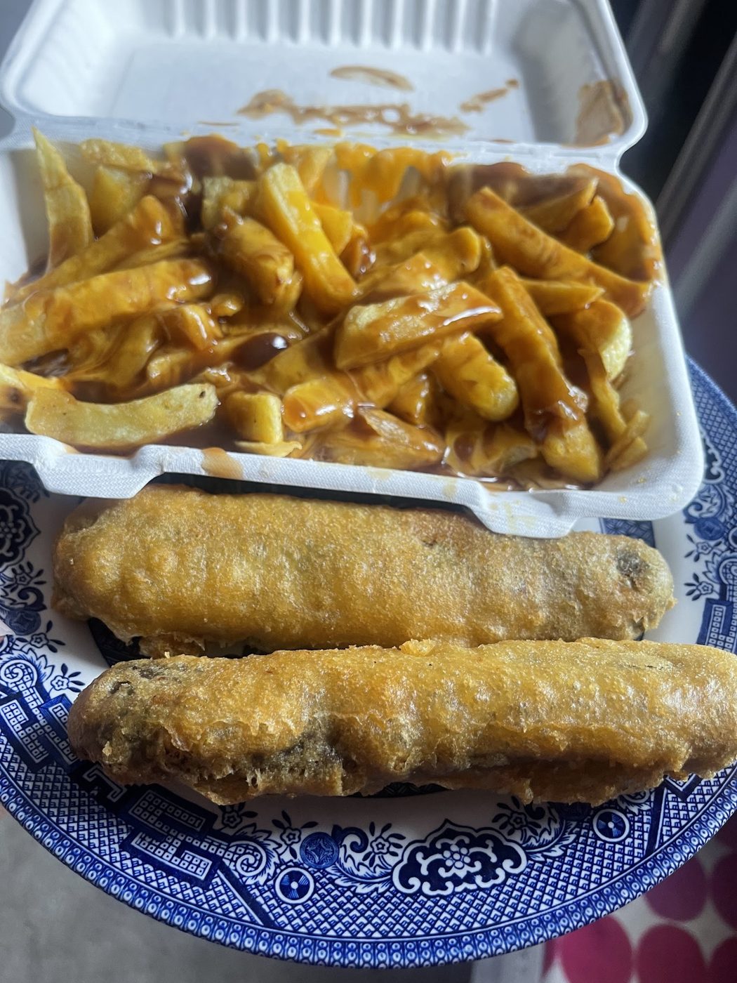 Chips with curry sauce and two battered sausages